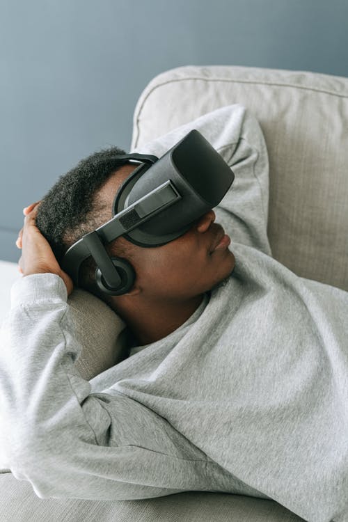 Man in Grey Sweater Wearing Virtual Reality