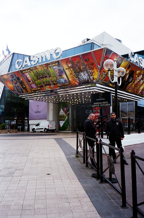 Free Two Men Standing Outside Casino Building Stock Photo